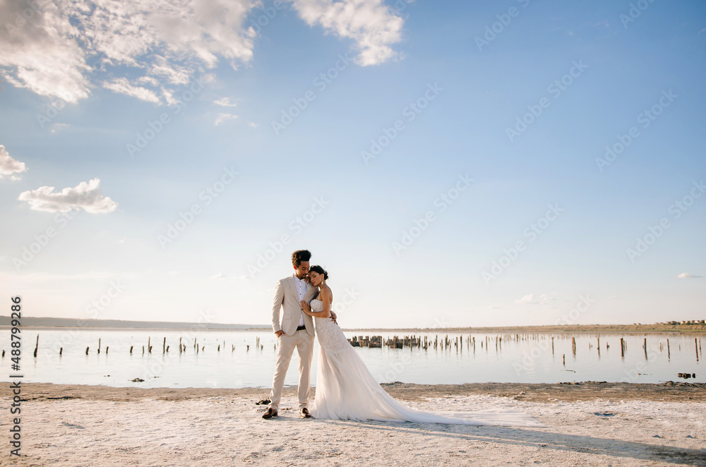 A beautiful romantic couple on an important day for them at sunset outside the city. Concept - love, romance, tenderness A beautiful romantic couple on an important day for them at sunset outside the city. Concept - love, romance, tenderness