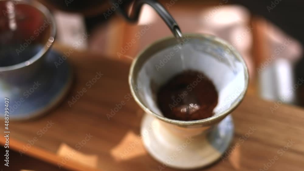 slow-motion shot of barista who making a hot of coffee by filter drip pouring water process, homemade coffee in morning slow-motion shot of barista who making a hot of coffee by filter drip pouring water process, homemade coffee in morning