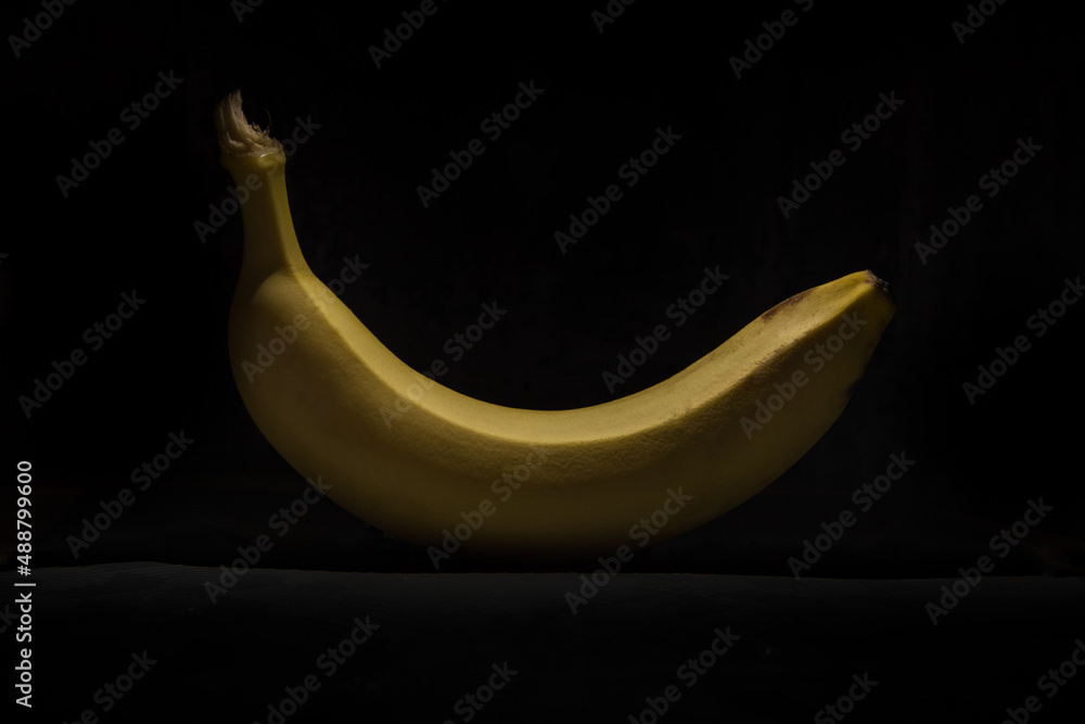 Yellow banana on a black background, banana in the dark Yellow banana on a black background, banana in the dark