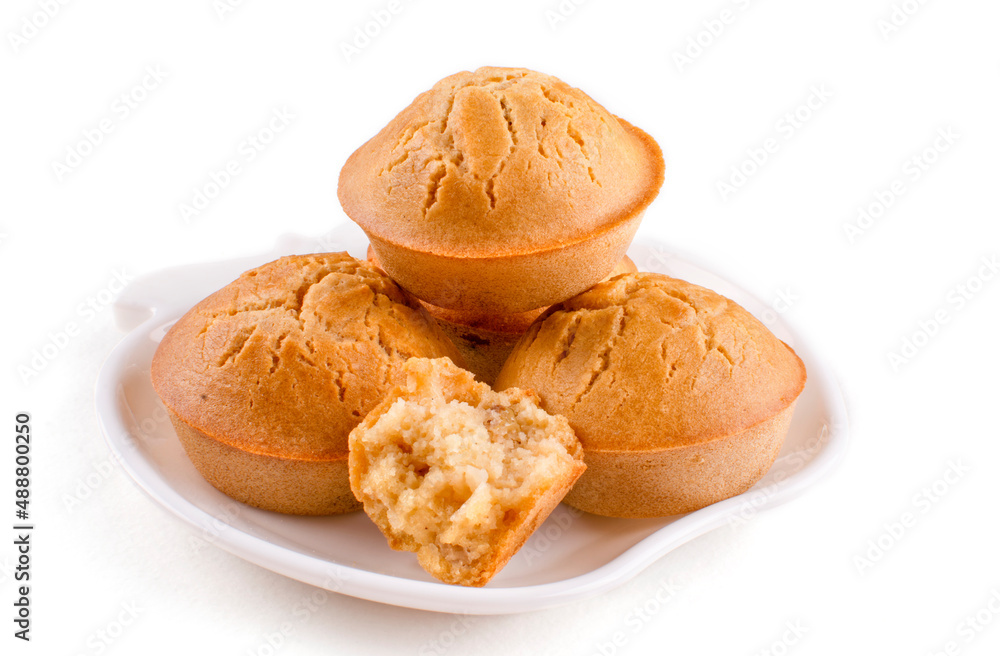 A stack of homemade cupcakes on a beautiful saucer close-up on a white isolated background. Rice flour muffins. The concept of proper nutrition, gluten-free diet, healthy lifestyle. Pattern. A stack of homemade cupcakes on a beautiful saucer close-up on a white isolated background. Rice flour muffins. The concept of proper nutrition, gluten-free diet, healthy lifestyle. Pattern.