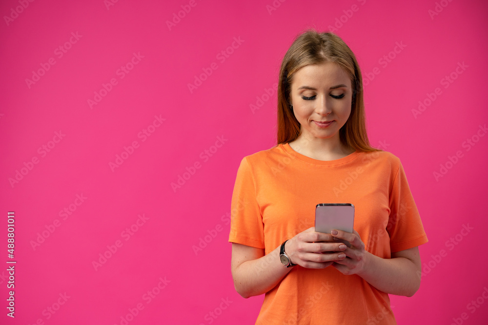 Portrait of a young woman using mobile phone over color background. Portrait of a young woman using mobile phone over color background.
