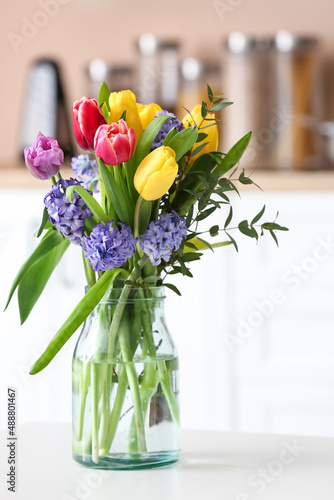 Bouquet of blooming flowers in vase on table