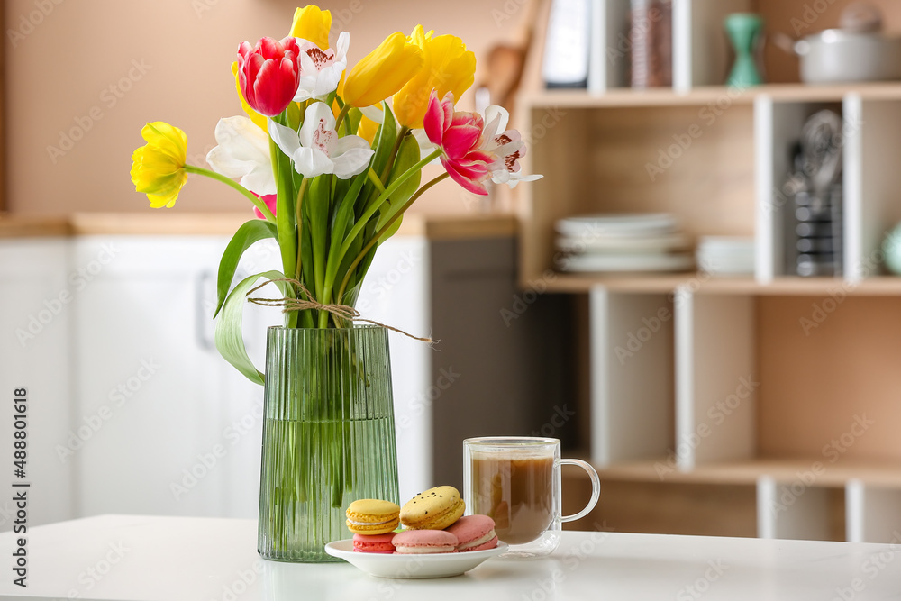 Vase with flowers and tasty breakfast on dining table in kitchen Vase with flowers and tasty breakfast on dining table in kitchen