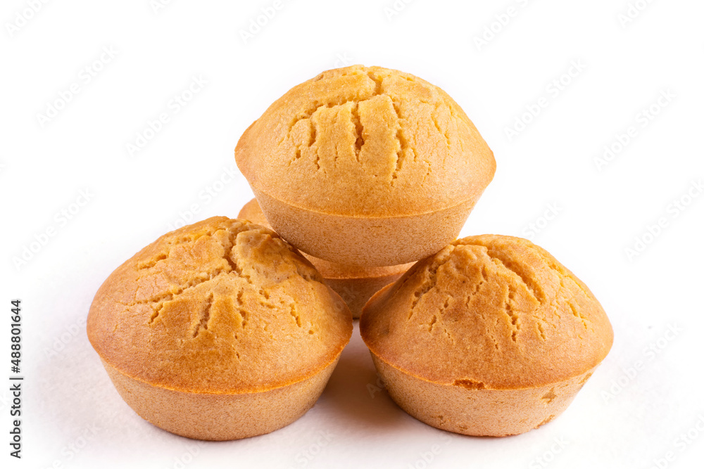 Four homemade rice cupcakes with raisins stacked on top of each other on a white isolated background. Rice flour muffins. The concept of proper nutrition, a gluten-free diet. Four homemade rice cupcakes with raisins stacked on top of each other on a white isolated background. Rice flour muffins. The concept of proper nutrition, a gluten-free diet.