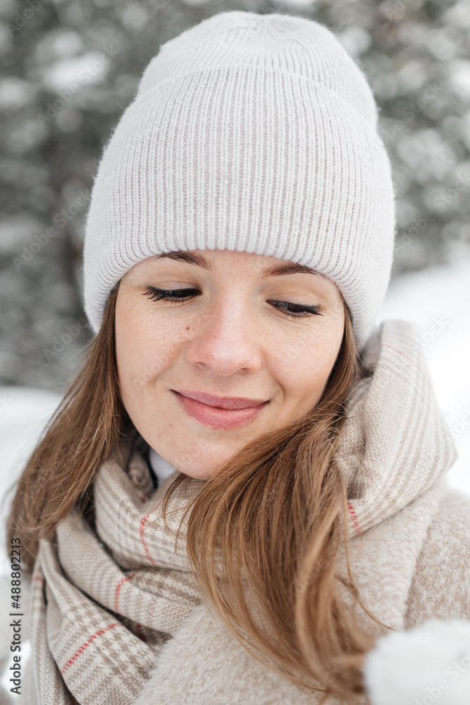 portrait of a girl in warm clothes in a winter forest. High quality photo portrait of a girl in warm clothes in a winter forest. High quality photo