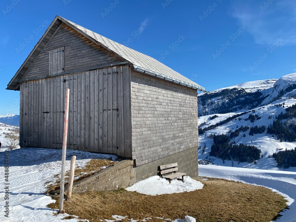 Indigenous alpine huts and wooden cattle stables on Swiss pastures covered with fresh white snow cover, Alt St. Johann - Obertoggenburg, Switzerland (Schweiz) Indigenous alpine huts and wooden cattle stables on Swiss pastures covered with fresh white snow cover, Alt St. Johann - Obertoggenburg, Switzerland (Schweiz)