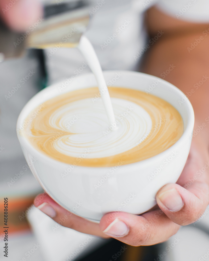 pouring milk into a cup pouring milk into a cup