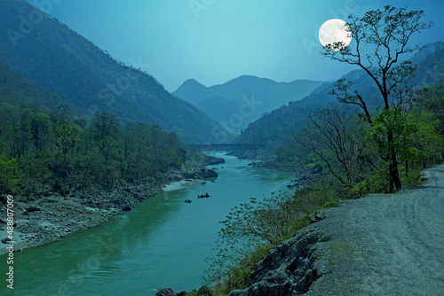 Ganga river in the Himalayas in India Asia with full moon photo