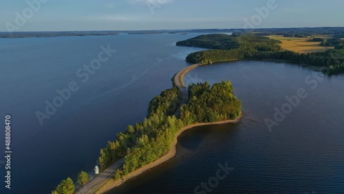 Aerial view of of islands on a blue lake Paijanne. Blue lake, islands and green forest from above on a sunny summer evening. Lake landscape in Finland