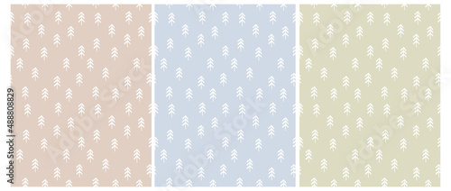 Simple Seamless Vector Patterns with White Hand Drawn Christmas Trees on a Light Blue, Beige and Pale Green Background. Winter Forest Print with Infantile Style Sketched Pine Trees.