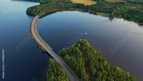 Aerial view of of islands on a blue lake Paijanne. Blue lake, islands and green forest from above on a sunny summer evening. Lake landscape in Finland