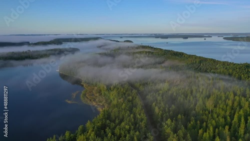 Aerial view of Pulkkilanharju Ridge, Paijanne National Park, southern part of Lake Paijanne. Landscape with drone. Blue lakes, road and green forests from above on a sunny summer day in Finland.