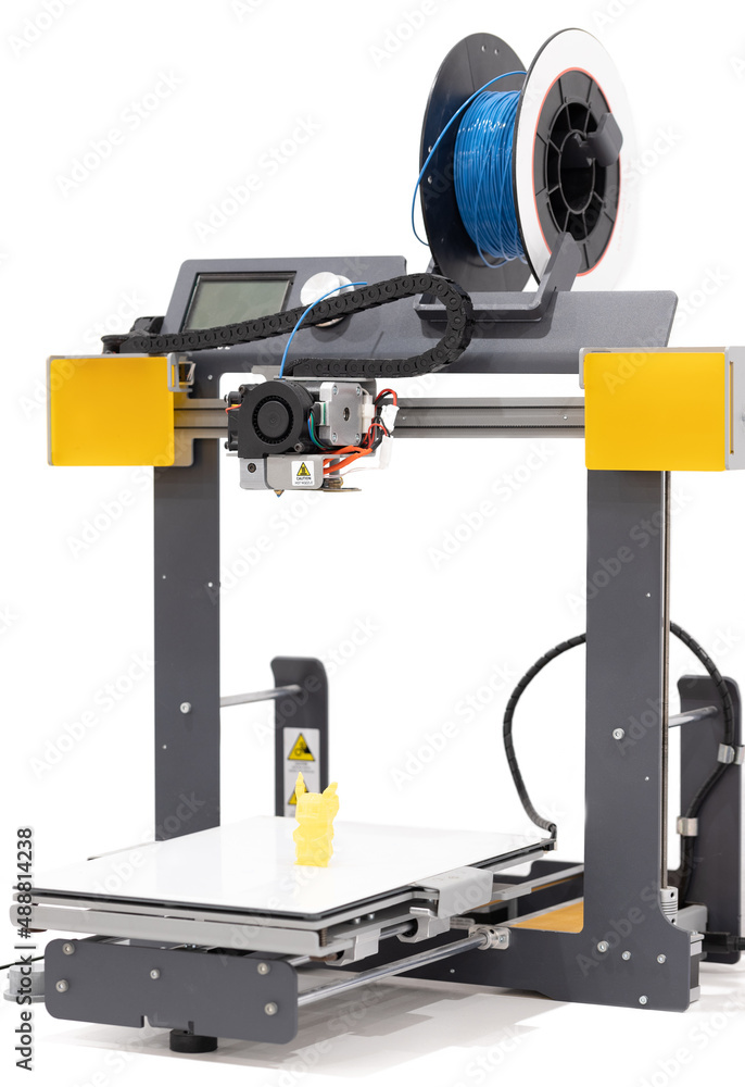 three dimensional printer with spool blue filament on a white background. three dimensional printer with spool blue filament on a white background.