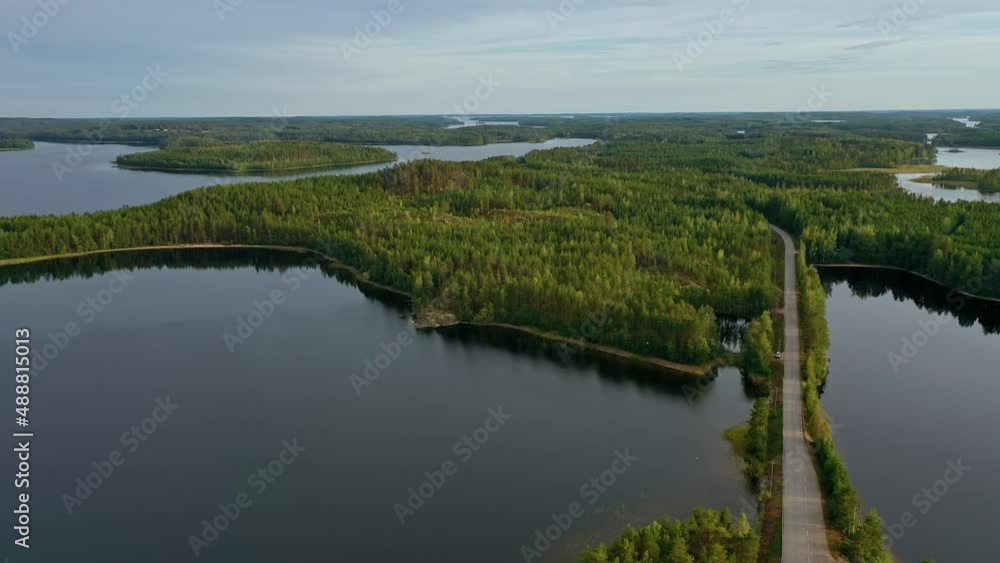 Aerial view of of small islands on a blue lake Saimaa. Landscape with drone. Blue lakes, islands and green forests from above on a cloudy summer morning. Lake landscape in Finland. Aerial view of of small islands on a blue lake Saimaa. Landscape with drone. Blue lakes, islands and green forests from above on a cloudy summer morning. Lake landscape in Finland.
