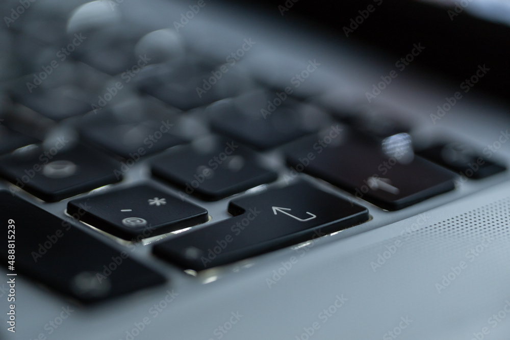 Laptop keyboard with focus on the inter button, close-up. Login and start concept Laptop keyboard with focus on the inter button, close-up. Login and start concept