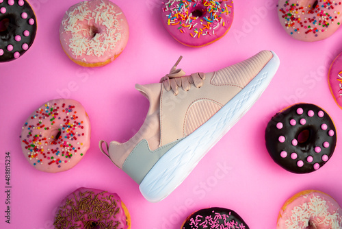 Fashion sneakers surrounded by pink donuts