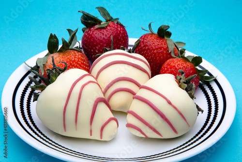 Strawberries with chocolate and nuts on a blue background