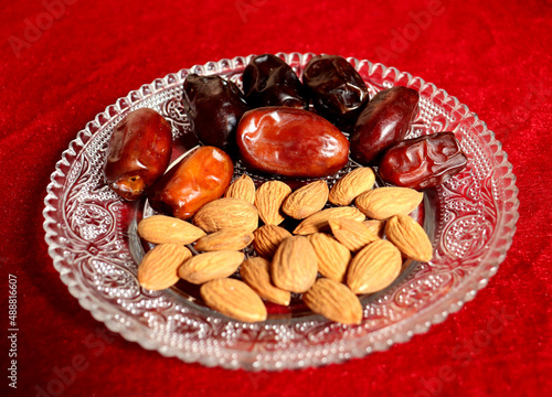 Healthy Dry food for breakfast,Almond and date on a glass plate,healthy food photo