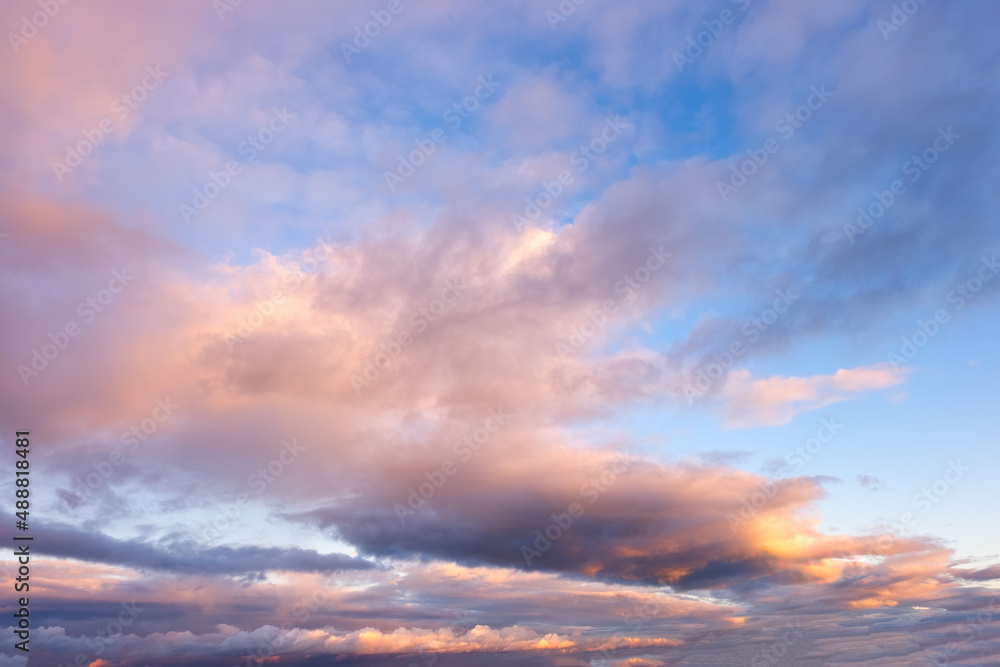 Beautiful dramatic sky at sunset or dawn with dark blue clouds and pink lighting