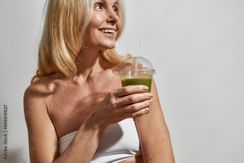 Partial image of woman drinking cocktail or juice Partial image of woman drinking cocktail or juice