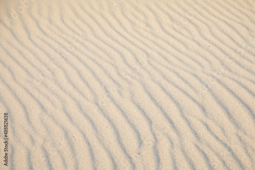 background of sandy beach with soft waves