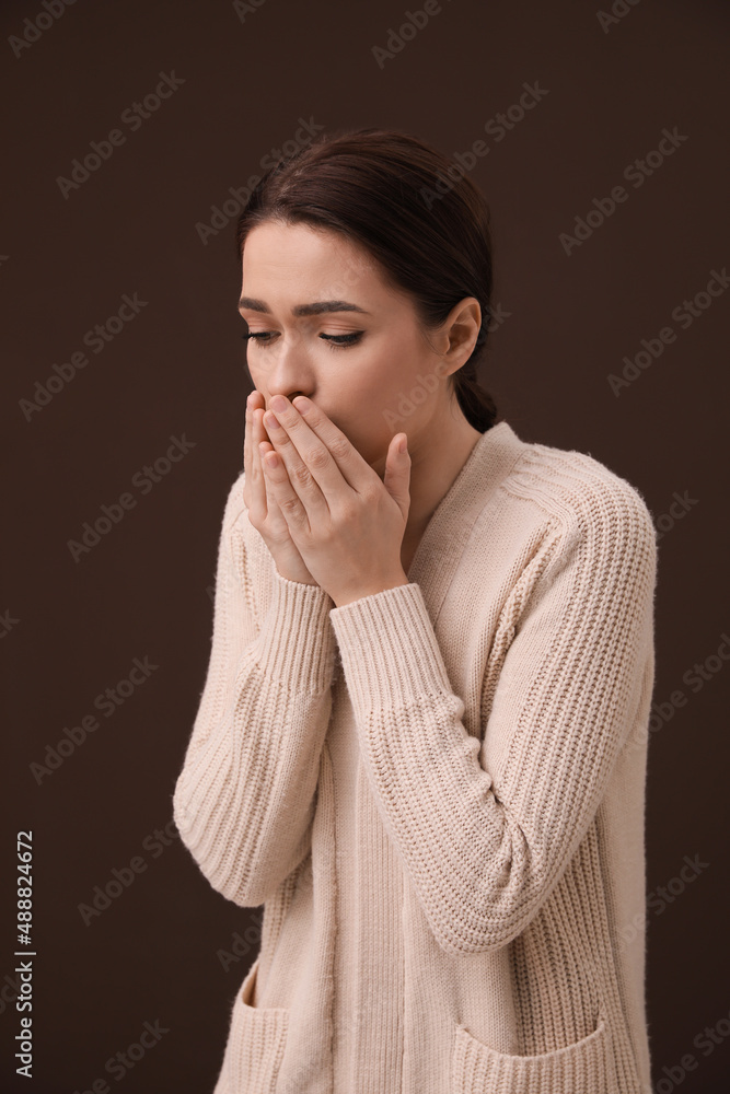 Woman coughing on brown background. Cold symptoms Woman coughing on brown background. Cold symptoms