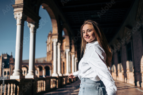Young smiling woman enjoying sightseeing in Seville, Spain