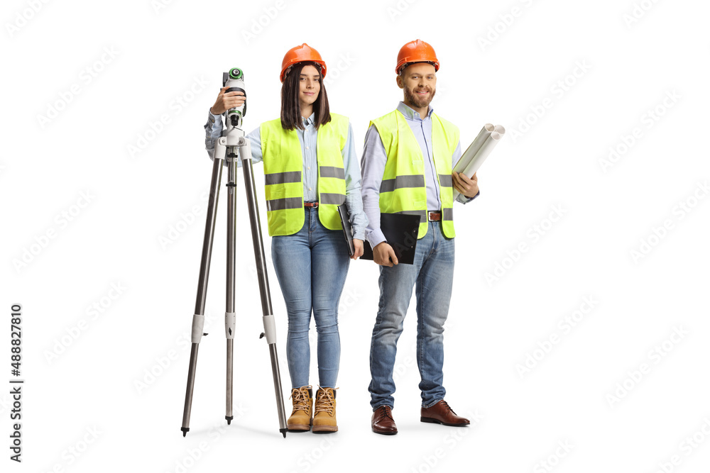 Female geodetic surveyor with a measuring device and a male engineer posing Female geodetic surveyor with a measuring device and a male engineer posing