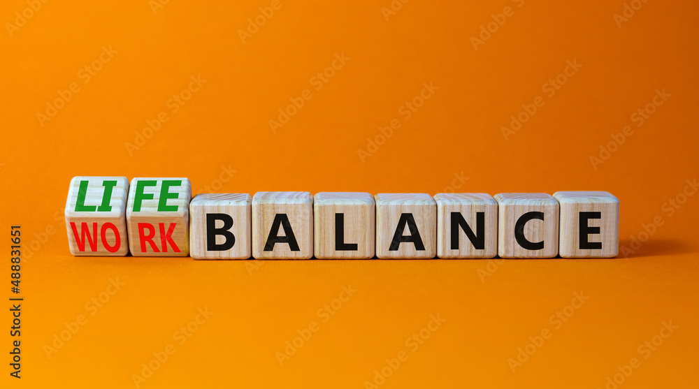 Work life balance symbol. Turned wooden cubes and changed concept words Work balance to Life balance. Beautiful orange table orange background. Business work life balance concept. Copy space. Work life balance symbol. Turned wooden cubes and changed concept words Work balance to Life balance. Beautiful orange table orange background. Business work life balance concept. Copy space.