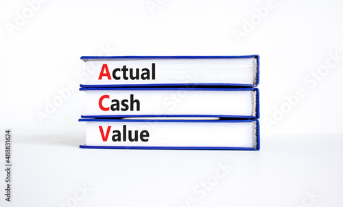 ACV actual cash value symbol. Concept words ACV actual cash value on books on a beautiful white table, white background. Business and ACV actual cash value concept. Copy space.