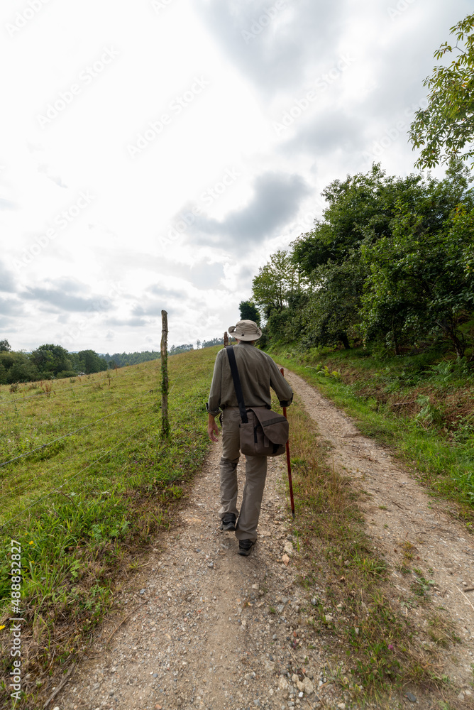 Backpacker pilgrim traveling the Camino de Santiago. Way of St James Backpacker pilgrim traveling the Camino de Santiago. Way of St James