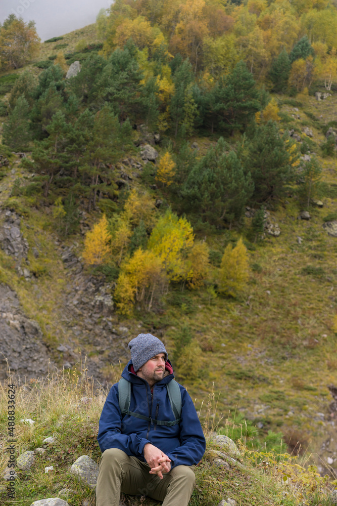 Man traveller, tourist with a backpack in mountains. Active life concept.