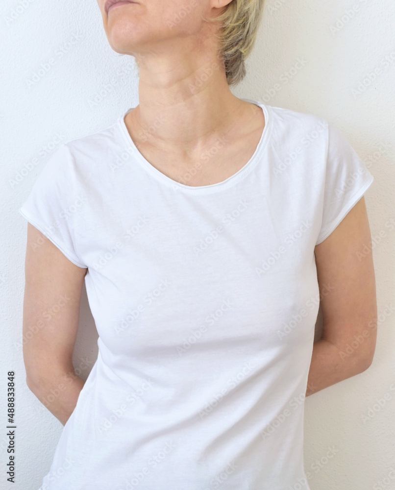 woman 50+ in white t-shirt no bra Stock Photo