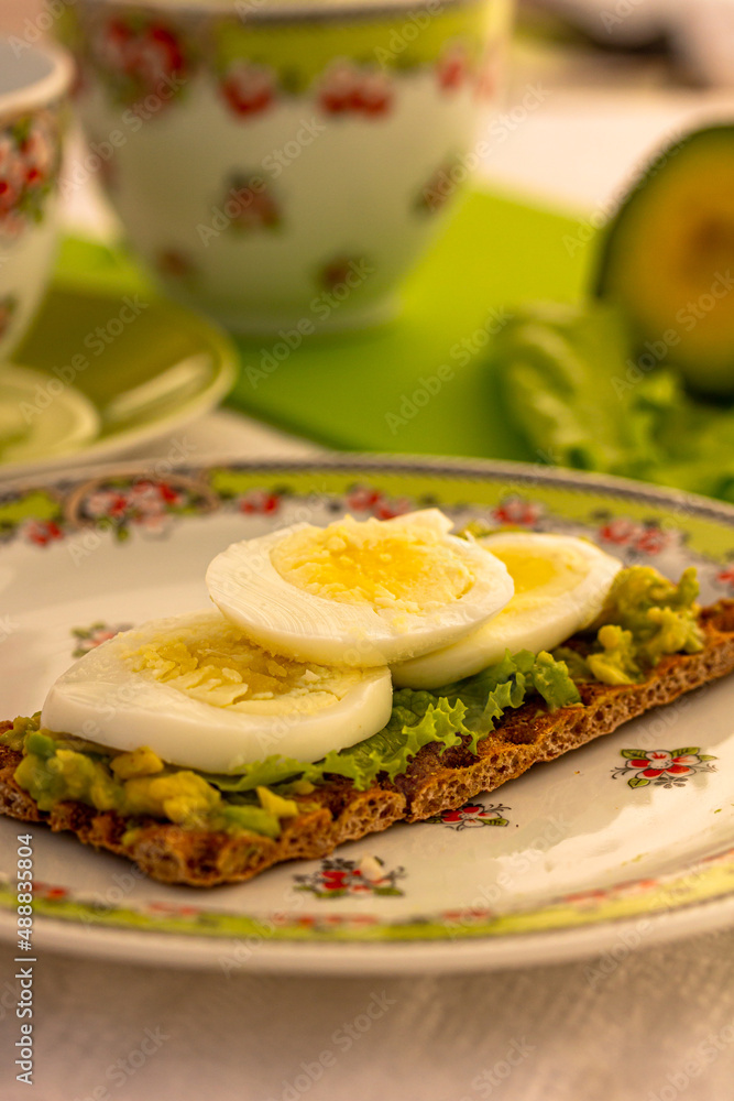 Quick and healthy breakfast concept. Avocado toast with egg on the table Quick and healthy breakfast concept. Avocado toast with egg on the table