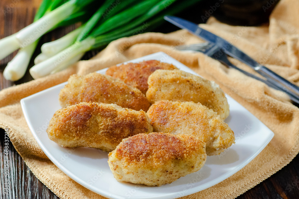Chicken patties or fish cakes fried in breadcrumbs Chicken patties or fish cakes fried in breadcrumbs