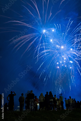 People watching beautiful blue fireworks