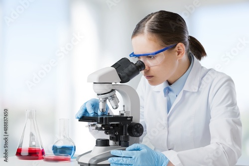 Professional female scientist is working on a vaccine in a scientific research laboratory. Technology and science concept.