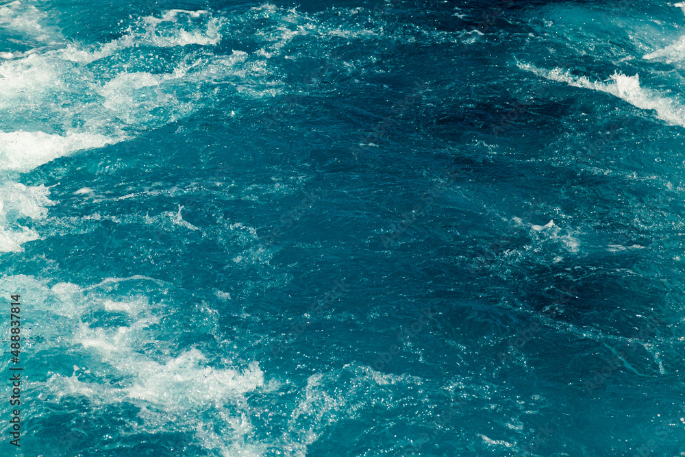 Stormy blue Aare river in Switzerland, close-up.