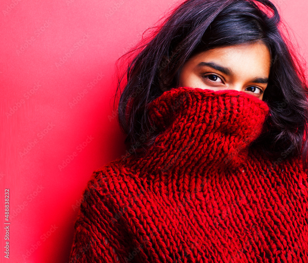 young pretty indian girl in red sweater posing emotional, fashion hipster teenage, lifestyle people concept young pretty indian girl in red sweater posing emotional, fashion hipster teenage, lifestyle people concept