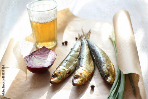 smoked herring with beer on a table