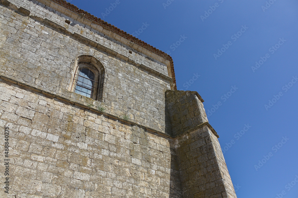 Close view of the coner of a medieval church in a village of Spain on a sunny spring day
