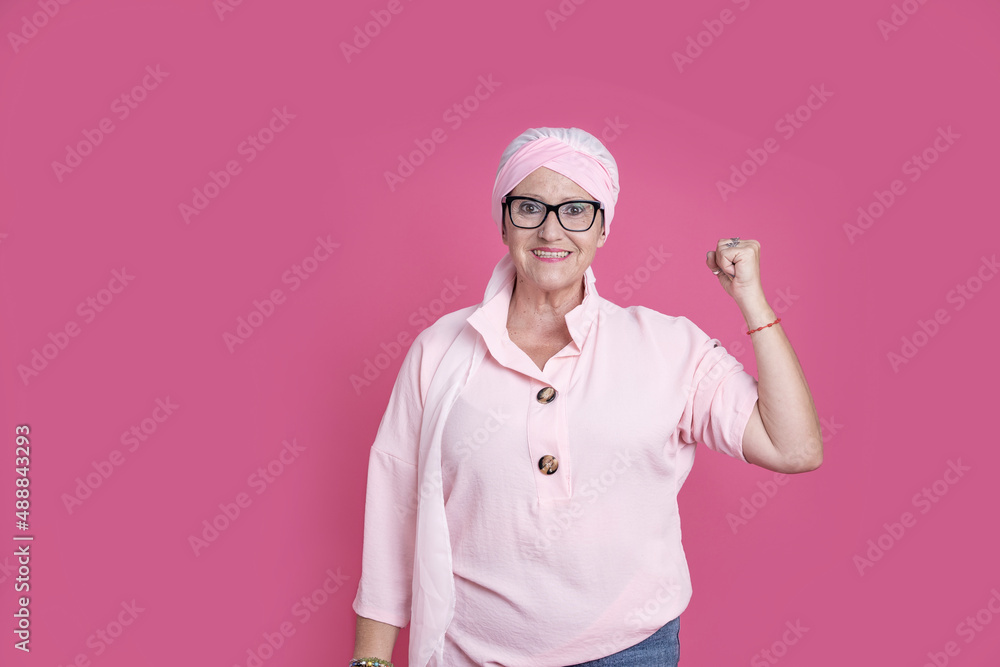Cheerful sick woman showing bicep for positive attitude Cheerful sick woman showing bicep for positive attitude