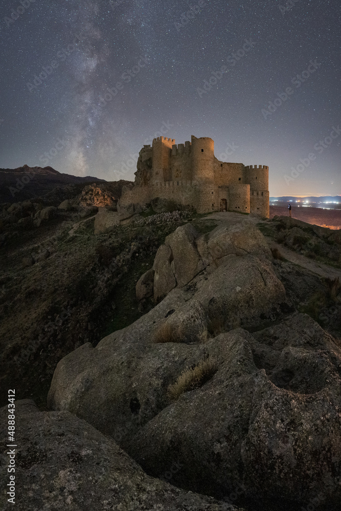 Medieval castle against starry sky at night time Medieval castle against starry sky at night time