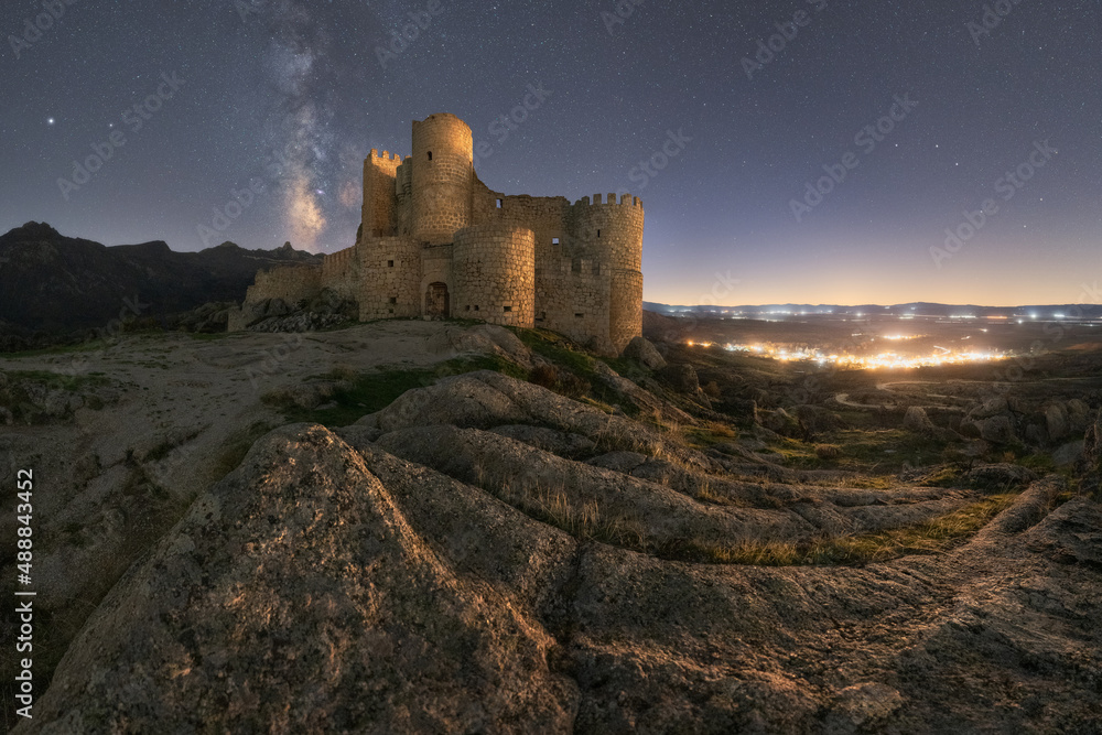 Medieval castle against starry sky at night time Medieval castle against starry sky at night time