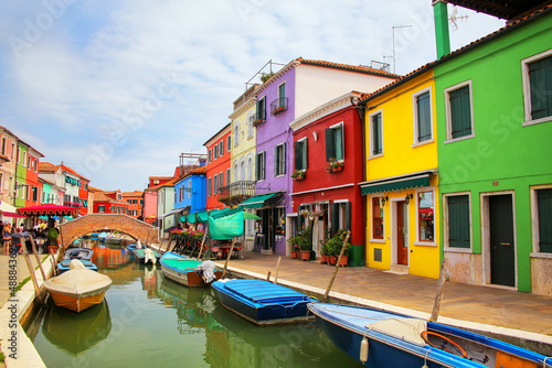 Colorful houses by canal in Burano, Venice, Italy.