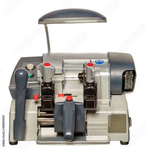 Industrial machine for making copies of keys for door locks. The image is isolated on a white background. Closeup.