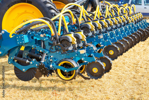 The wheel mechanism of a multi-row seeder as a hitch to a tractor on the background of an agricultural field. photo