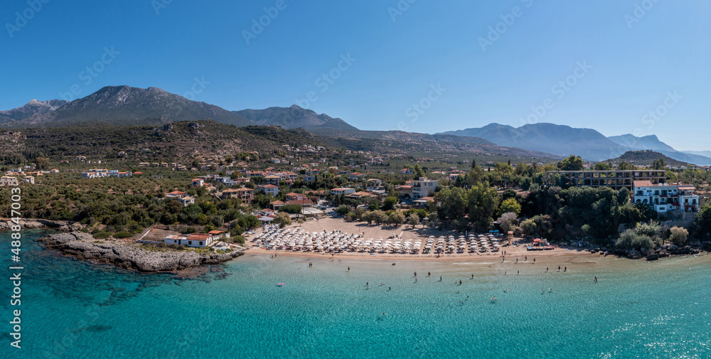 Greece, sandy beach, aerial drone view. People swim and relax at Stoupa beach Mani, Peloponnese.