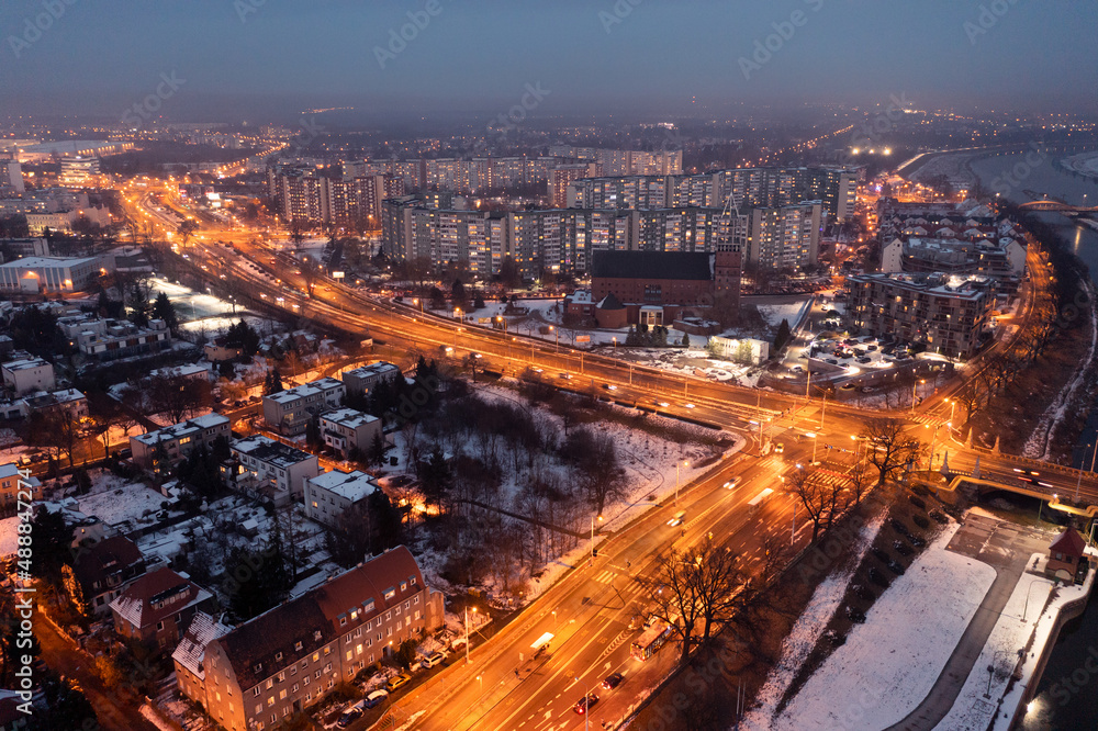 Aerial view of the evening Polish city of Wroclaw, illuminated streets and houses in the evening, roads in the city in the evening. urban landscape