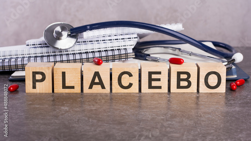 PLACEBO text on wooden blocks, medical concept, gray background photo